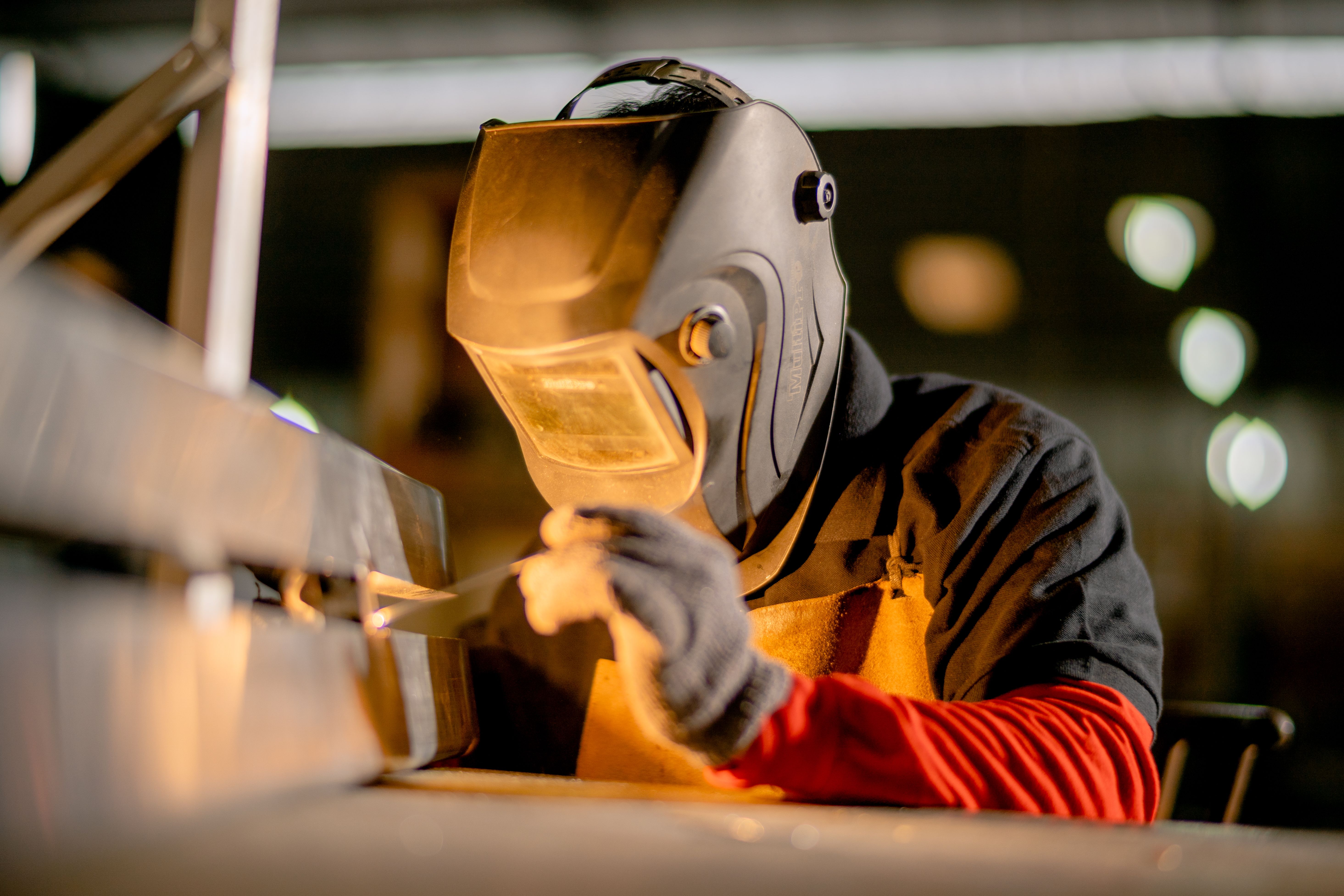 Industrial operator reviewing data on a tablet on the factory floor