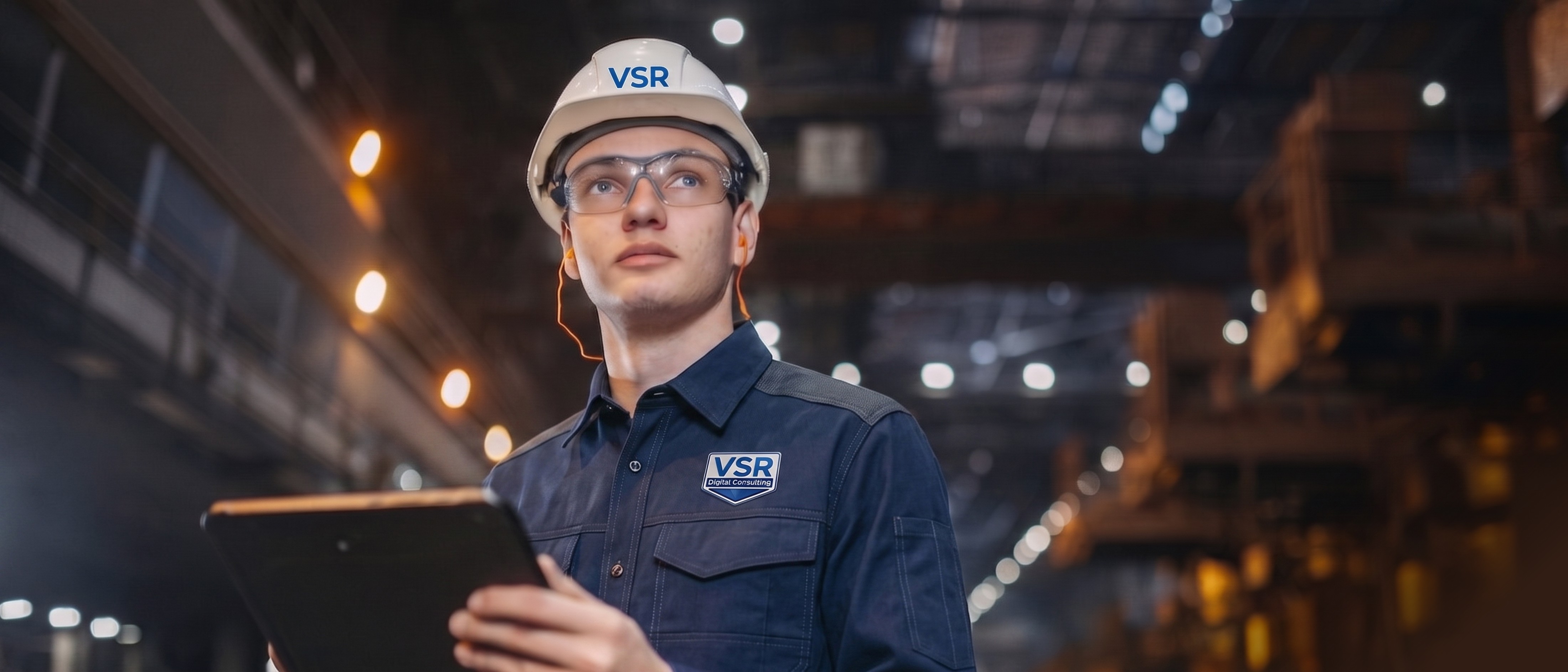 Factory worker reviewing live data on a tablet on the production floor