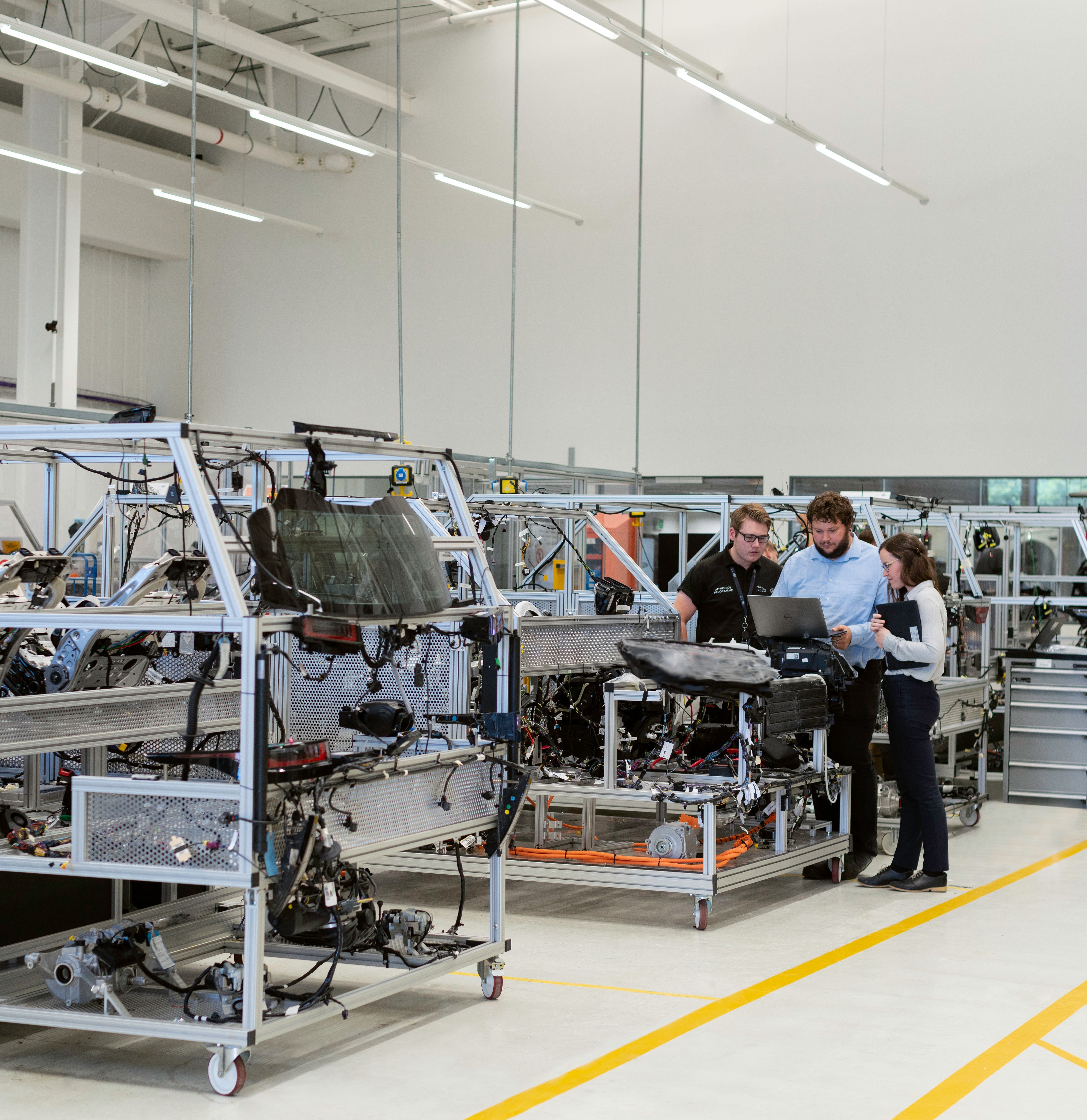 A VSR Digital-style delivery team reviewing a solution together on the shop floor